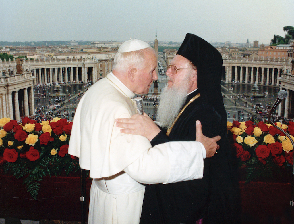 St. Pope John Paul II and Ecumenical Patriarch Bartholomew of Constantinople embrace on the balcony of St. Peter's Basilica following three days of private meetings in 1995. Twenty-five years ago St. John Paul's encyclical on ecumenism, "Ut Unum Sint," put the papal seal of approval on a shift in the Catholic Church's approach to the search for Christian unity. (CNS photo/Arturo Mari, L'Osservatore Romano) See UT-UNUM-SINT-BAMBERA of May 26, 2020.